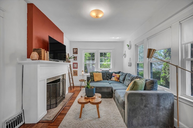19 Orpington St, Hamden, CT 06517 - living room featuring dark wood finished floors, a brick fireplace, and baseboards