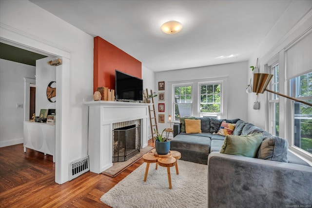 19 Orpington St, Hamden, CT 06517 - living room featuring plenty of natural light, wood finished floors, a brick fireplace, and baseboards