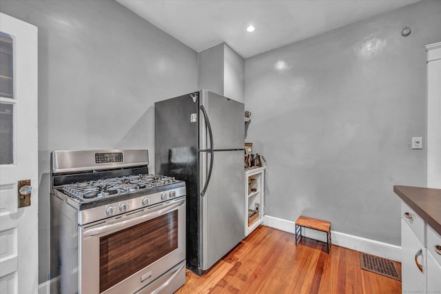 19 Orpington St, Hamden, CT 06517 - kitchen featuring stainless steel appliances, light wood-style flooring, baseboards, dark countertops, and recessed lighting