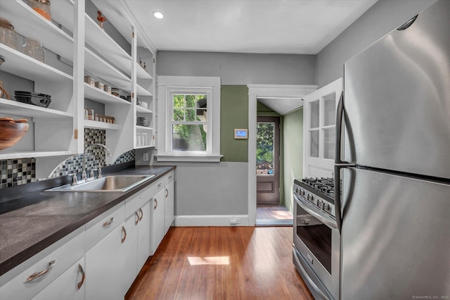 19 Orpington St, Hamden, CT 06517 - kitchen with stainless steel appliances, a sink, dark countertops, white cabinets, and hardwood / wood-style flooring