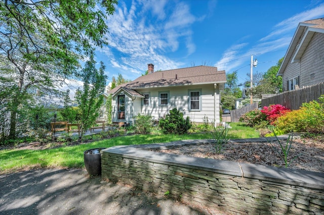 19 Orpington St, Hamden, CT 06517 - rear view of house with fence and a chimney