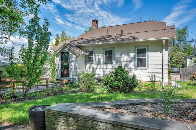 19 Orpington St, Hamden, CT 06517 - rear view of property with a chimney, fence, and roof with shingles