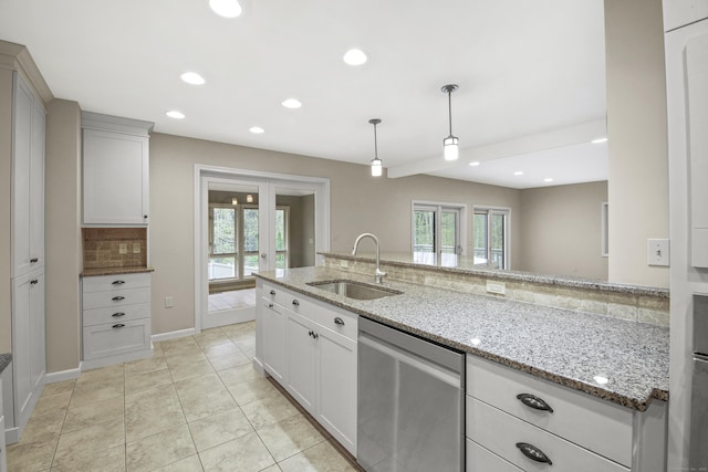 kitchen featuring a sink, stainless steel dishwasher, healthy amount of natural light, recessed lighting, and light tile patterned floors