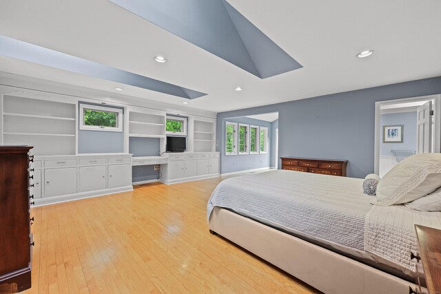 bedroom featuring wood-type flooring, recessed lighting, a skylight, and baseboards
