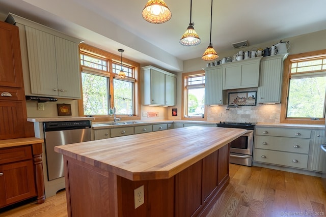 49 Bayberry Ln, Groton, CT 06340 - kitchen with butcher block counters, appliances with stainless steel finishes, light wood-style flooring, and decorative light fixtures