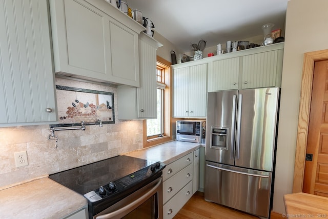 49 Bayberry Ln, Groton, CT 06340 - kitchen featuring stainless steel appliances, light countertops, and decorative backsplash