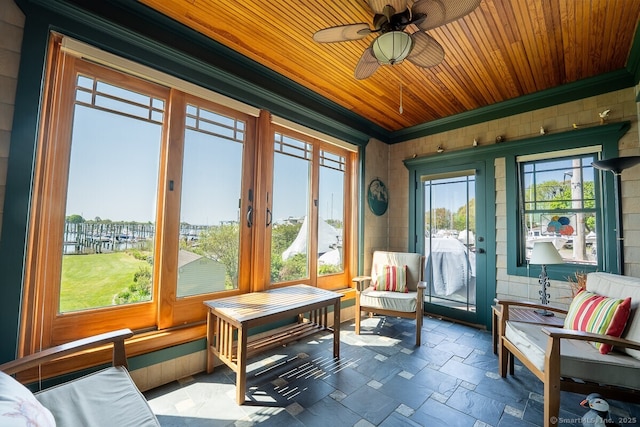49 Bayberry Ln, Groton, CT 06340 - sunroom / solarium with crown molding, wooden ceiling, stone finish flooring, wood walls, and french doors