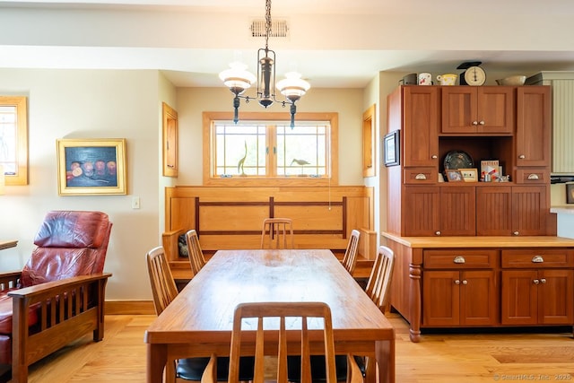 49 Bayberry Ln, Groton, CT 06340 - dining room featuring light wood-style flooring and a chandelier