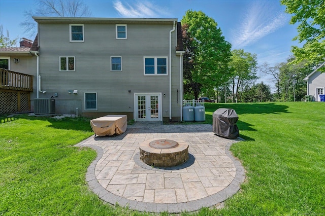 7 Beechwood Cir, Cromwell, CT 06416 - rear view of property featuring french doors, an outdoor fire pit, a patio, a yard, and cooling unit