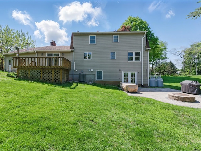 7 Beechwood Cir, Cromwell, CT 06416 - back of house featuring french doors, a deck, central AC, a lawn, and a patio