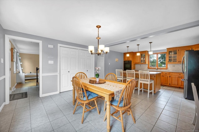 7 Beechwood Cir, Cromwell, CT 06416 - dining area with light tile patterned floors, a chandelier, and baseboards