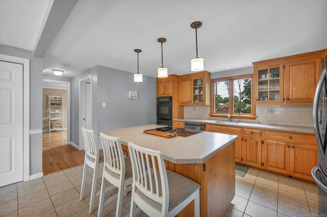 7 Beechwood Cir, Cromwell, CT 06416 - kitchen with light tile patterned floors, a sink, light countertops, tasteful backsplash, and a center island