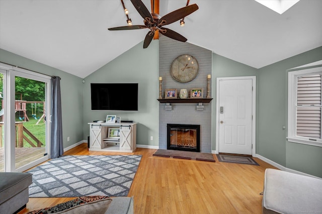 7 Beechwood Cir, Cromwell, CT 06416 - living room with a fireplace, vaulted ceiling, ceiling fan, wood finished floors, and baseboards