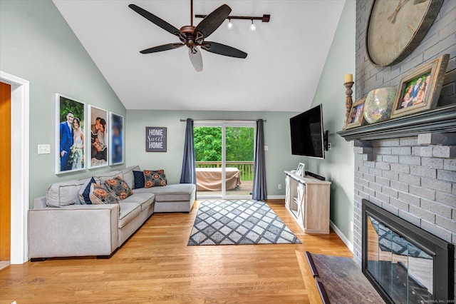7 Beechwood Cir, Cromwell, CT 06416 - living area with a ceiling fan, a fireplace, light wood-type flooring, high vaulted ceiling, and baseboards