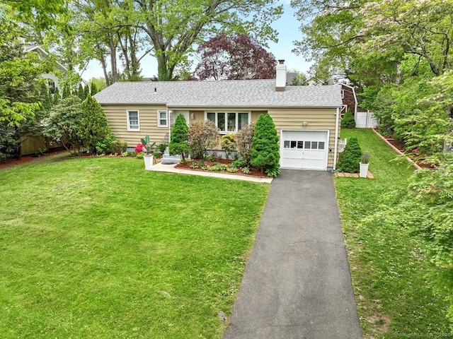 ranch-style house featuring an attached garage, driveway, and a chimney