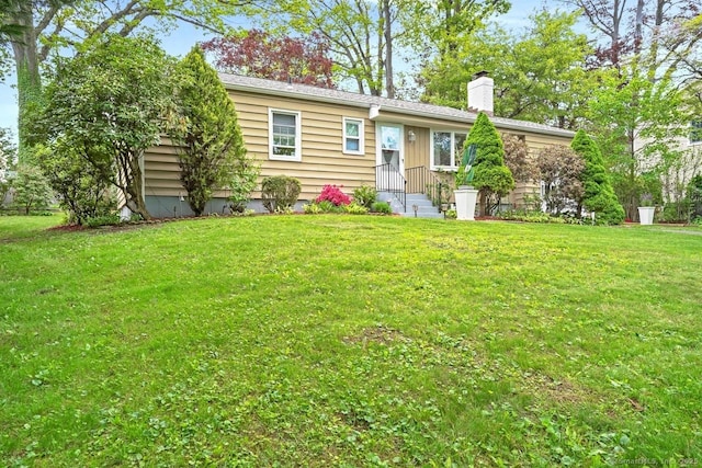 view of front of property with a front lawn and a chimney
