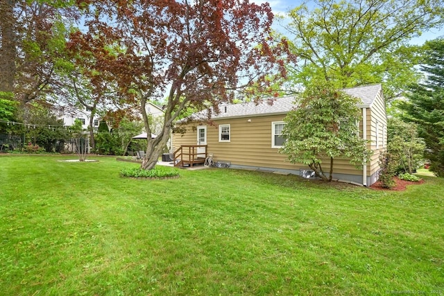 back of property featuring a lawn