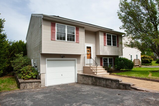 4 Fox Run Ln, New Hartford, CT 06057 - split foyer home featuring an attached garage and asphalt driveway