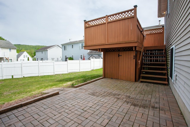 view of patio featuring stairway and a residential view