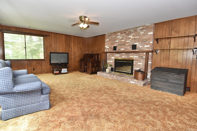 12 Cedar Ln, Oxford, CT 06478 - carpeted living area with wooden walls, a ceiling fan, and a fireplace
