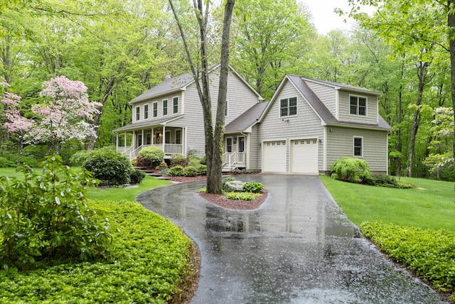 79 Erdoni Rd, Columbia, CT 06237 - view of front of home featuring asphalt driveway, covered porch, a front yard, an attached garage, and a chimney