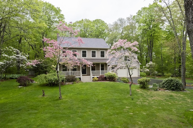 79 Erdoni Rd, Columbia, CT 06237 - colonial house featuring covered porch, driveway, a front yard, and an attached garage