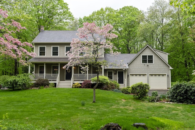 79 Erdoni Rd, Columbia, CT 06237 - view of front facade with a chimney, a garage, a front yard, covered porch, and driveway