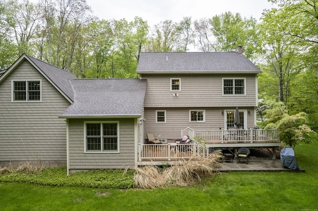 79 Erdoni Rd, Columbia, CT 06237 - back of house with a shingled roof, a deck, a chimney, a lawn, and a patio