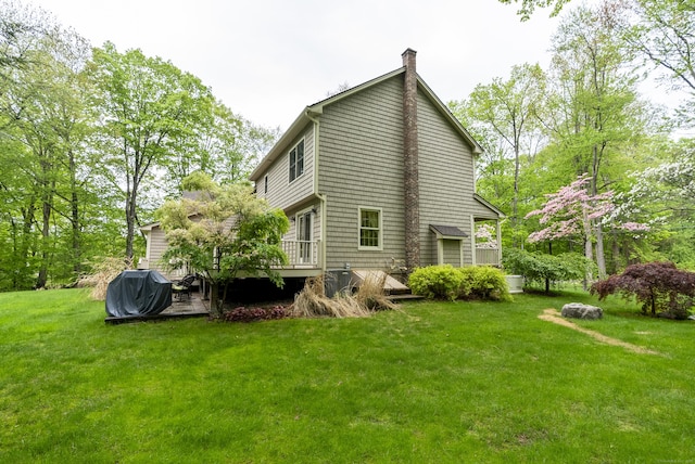 79 Erdoni Rd, Columbia, CT 06237 - back of property featuring a wooden deck, a chimney, and a lawn