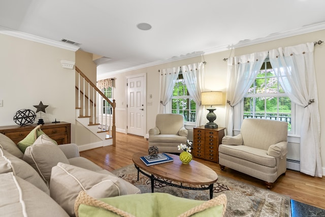 79 Erdoni Rd, Columbia, CT 06237 - living area featuring ornamental molding, wood finished floors, stairway, baseboards, and baseboard heating