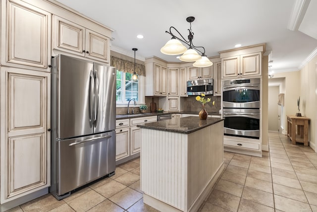 79 Erdoni Rd, Columbia, CT 06237 - kitchen with appliances with stainless steel finishes, cream cabinets, a sink, crown molding, and a kitchen island