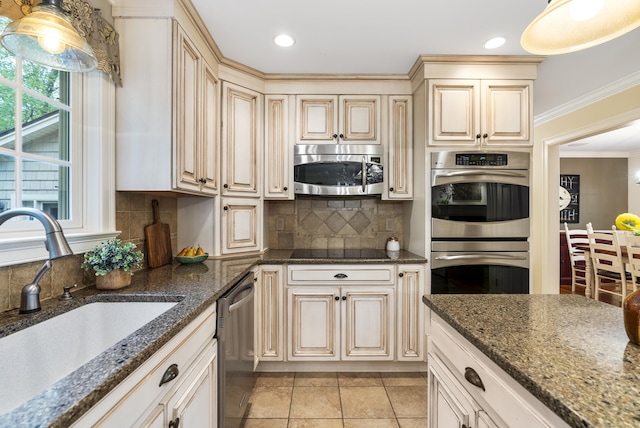 79 Erdoni Rd, Columbia, CT 06237 - kitchen featuring appliances with stainless steel finishes, a sink, cream cabinetry, backsplash, and ornamental molding