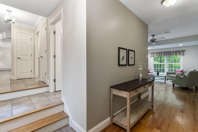 79 Erdoni Rd, Columbia, CT 06237 - corridor featuring a chandelier, baseboards, baseboard heating, and ornamental molding