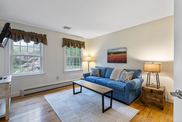 79 Erdoni Rd, Columbia, CT 06237 - living area with baseboard heating, light wood finished floors, and baseboards