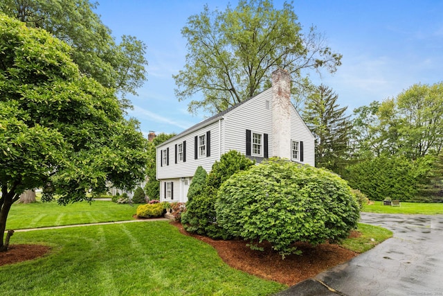 46 Glenbrook Rd, West Hartford, CT 06107 - view of home's exterior featuring a chimney and a yard