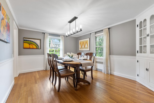 46 Glenbrook Rd, West Hartford, CT 06107 - dining room featuring radiator heating unit, healthy amount of natural light, light wood-style floors, ornamental molding, and a chandelier