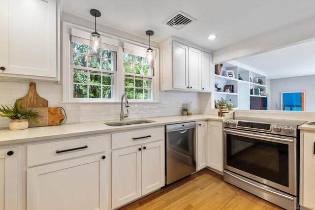 46 Glenbrook Rd, West Hartford, CT 06107 - kitchen featuring stainless steel appliances, a sink, white cabinetry, and decorative backsplash