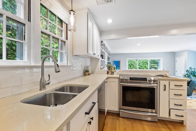 46 Glenbrook Rd, West Hartford, CT 06107 - kitchen featuring appliances with stainless steel finishes, a sink, light countertops, light wood-style flooring, and backsplash