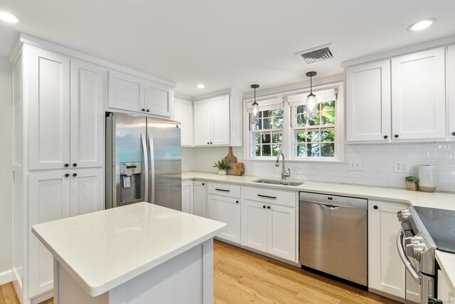 46 Glenbrook Rd, West Hartford, CT 06107 - kitchen featuring stainless steel appliances, a sink, light wood-type flooring, backsplash, and recessed lighting