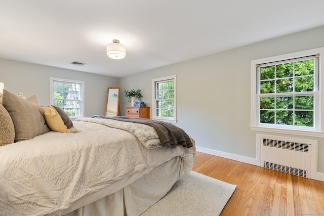 46 Glenbrook Rd, West Hartford, CT 06107 - bedroom with radiator heating unit, light wood-style floors, multiple windows, and baseboards