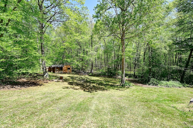 7 Stonegate Rd, East Hampton, CT 06424 - view of green lawn featuring a wooded view and an outbuilding