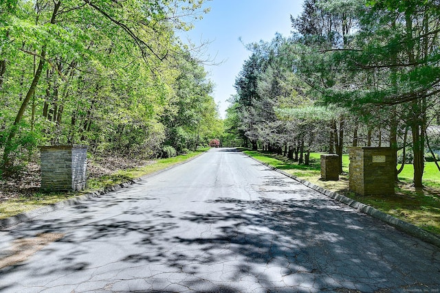 7 Stonegate Rd, East Hampton, CT 06424 - view of asphalt road with curbs and a wooded view