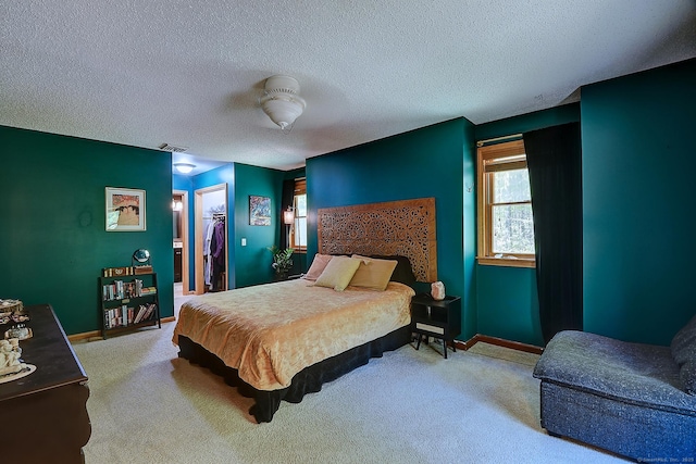 7 Stonegate Rd, East Hampton, CT 06424 - bedroom featuring a textured ceiling, carpet flooring, a walk in closet, baseboards, and a closet