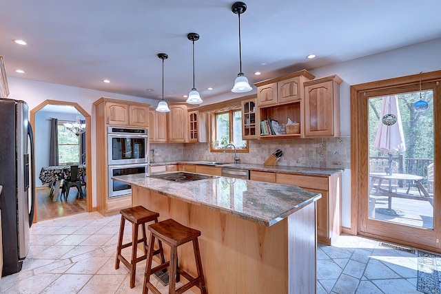 7 Stonegate Rd, East Hampton, CT 06424 - kitchen with stainless steel appliances, recessed lighting, stone tile flooring, a sink, and arched walkways