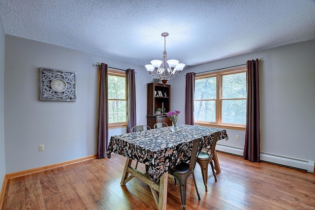 7 Stonegate Rd, East Hampton, CT 06424 - dining space with a chandelier, healthy amount of natural light, light wood finished floors, and a textured ceiling