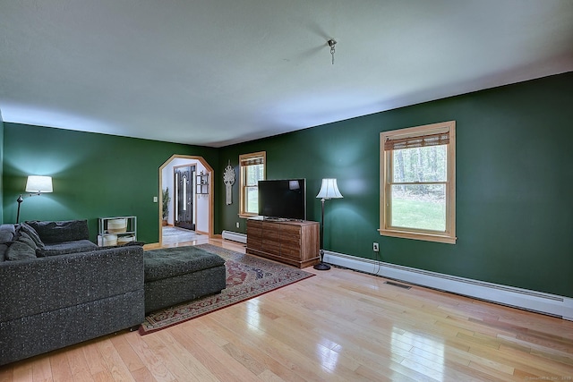 7 Stonegate Rd, East Hampton, CT 06424 - living room with baseboard heating, hardwood / wood-style flooring, arched walkways, and baseboards