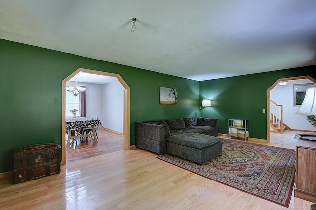 7 Stonegate Rd, East Hampton, CT 06424 - living area featuring arched walkways, wood finished floors, and baseboards