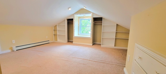 additional living space featuring baseboard heating, carpet, vaulted ceiling, built in features, and baseboards