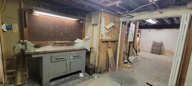 unfinished basement with a workshop area