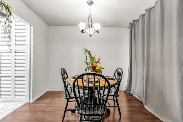 173 Kennedy Dr Unit 173, Bridgeport, CT 06606 - dining space featuring a chandelier, dark wood-style flooring, and baseboards